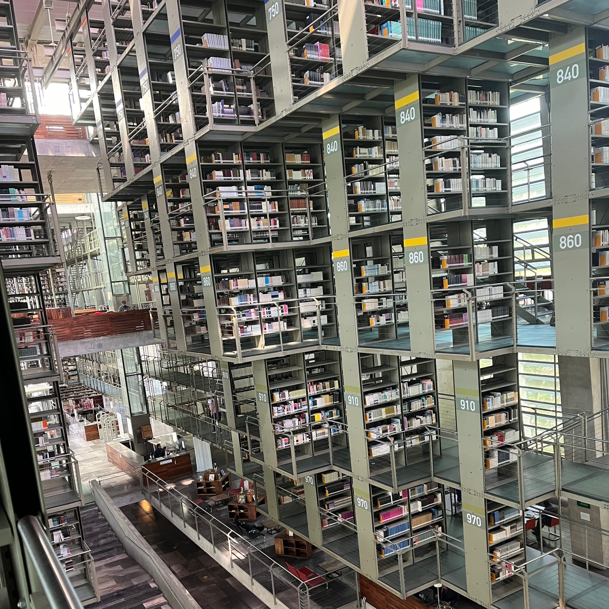 photograph of the interior of a mutli-floor library without walls so that all the shelves for all the floors are visble at once