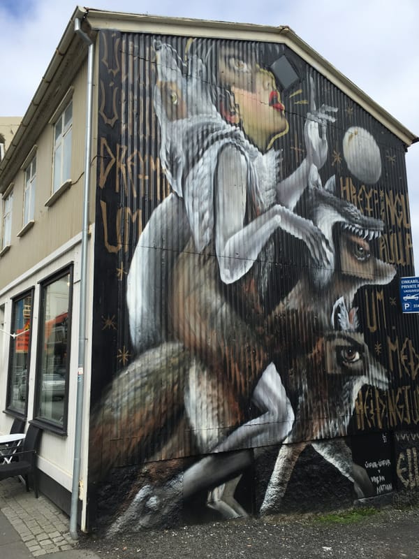 Photo of the side of a building with graffiti that uses imagery of the Maurice Sendak book "Where the Wild Things Are"